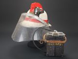 a helmet with a vise and a chest with a box