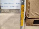 a metal pole with a yellow sticker on it