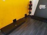 a yellow wall and a black floor in a gym