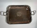 an antique silver tray with handles and handles on a white surface