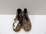 leopard print shoes with black laces and a tag on the sole