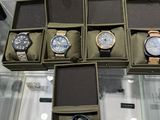 several watches are displayed in a display case on a glass table
