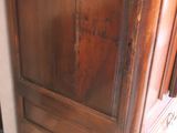 a wooden cabinet with a mirror on top of it