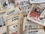 several old newspapers are piled on top of each other on a table