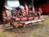 a toy tractor and a plow in a field