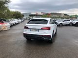 a lot of cars parked in a parking lot on a cloudy day