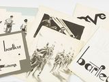 a lot of old black and white photos on a table