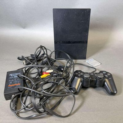beaucoup de câbles et une manette de jeu vidéo sur la table