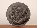a close up of a metal plate with a group of people on it