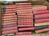 a box full of old books sitting on a table