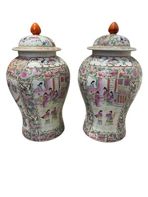 pair of chinese vases with asian scenes on them on a white background