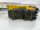 a toy train that is sitting on a table next to a box