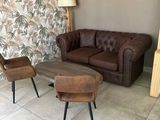 two chairs and a couch in a living room