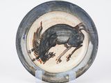 a plate with a picture of a goat on it