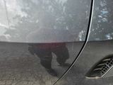 a reflection of a person in a car ' s side mirror