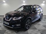 the black nissan suv is parked on a checkered floor