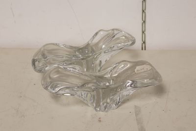 a clear glass bowl on a table with a flower in it