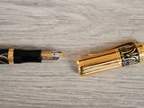 a pen that is laying on a wooden table