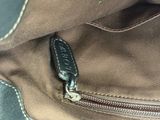 a close up of a brown bag with a zipper