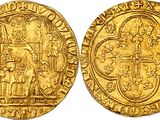 a gold coin with an image of a man holding a cross