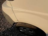 a white car that is parked on the side of the road