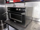 a microwave that is sitting on a table in a kitchen