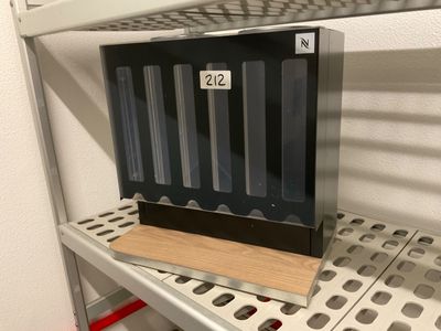 a metal shelf with a black box on top of it