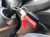 a car key that is attached to a keychain in a car