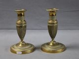 pair of antique brass candlesticks on a white background