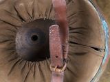 a brown hat with a brown leather strap on it