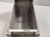 a metal box with two cups in it on a table