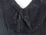 the back of a black dress with a frillying collar