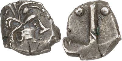 a silver coin with a design on the front and back of it