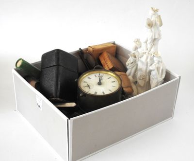 a white box with a clock and other items in it