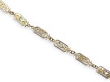 a close up of a gold bracelet with a chain on a white background
