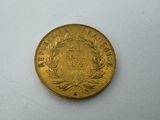 a close up of a gold coin on a white surface