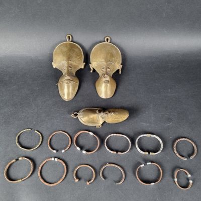 some gold rings and a pair of shoes are laying on a table