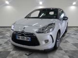 the small white car is parked on a checkered tile floor