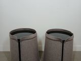 a pair of round stools with a black stripe on the top