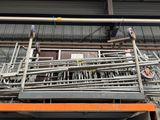 a large pile of pipes and pipes on the side of a building