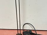 a lamp that is on the ground next to a wall