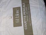 a white bag with a brown stripe on it sitting on a bed
