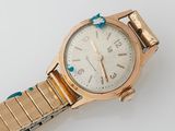 an image of a close up of a wrist watch on a white surface