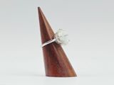 sterling silver ring with white topaz stone on a wooden cone