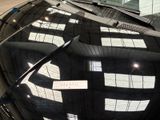 a reflection of a building on the windshield of a car