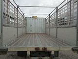 an image of a flat bed truck parked in a parking lot