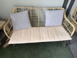 a couch with two pillows on it in a room