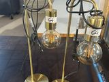three lamps that are sitting on a table