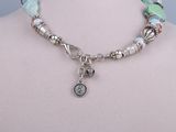 turquoise and silver beaded necklace with a silver charm and a heart charm