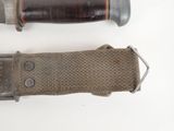 two different types of knives on a white surface